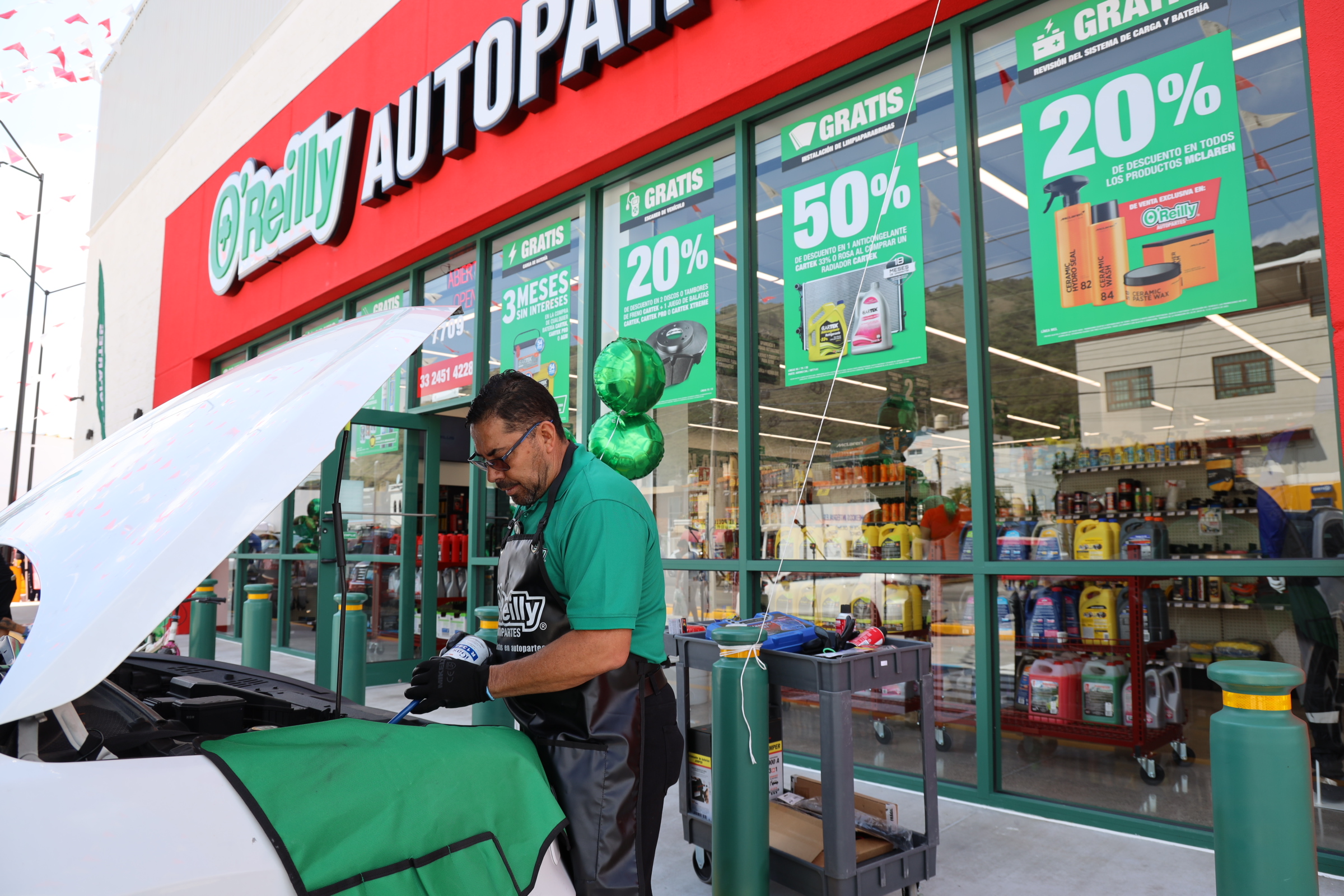 An O'Reilly team member checks a car for a customer in Guadalajara, Mexico.