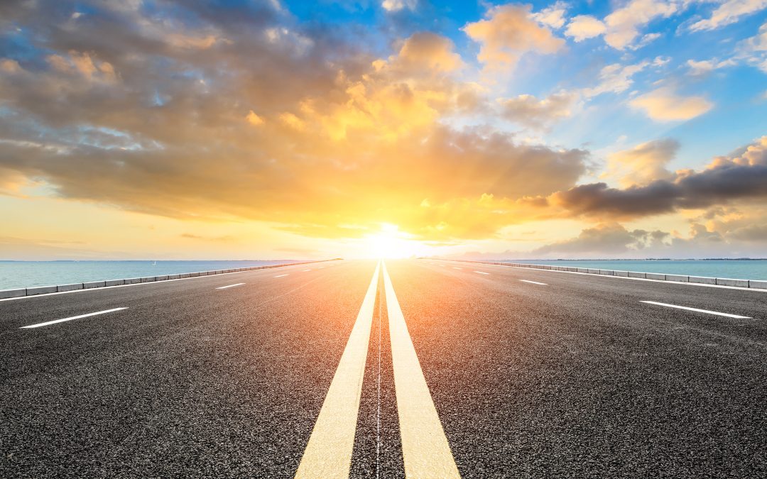 The sun coming up over a roadway
