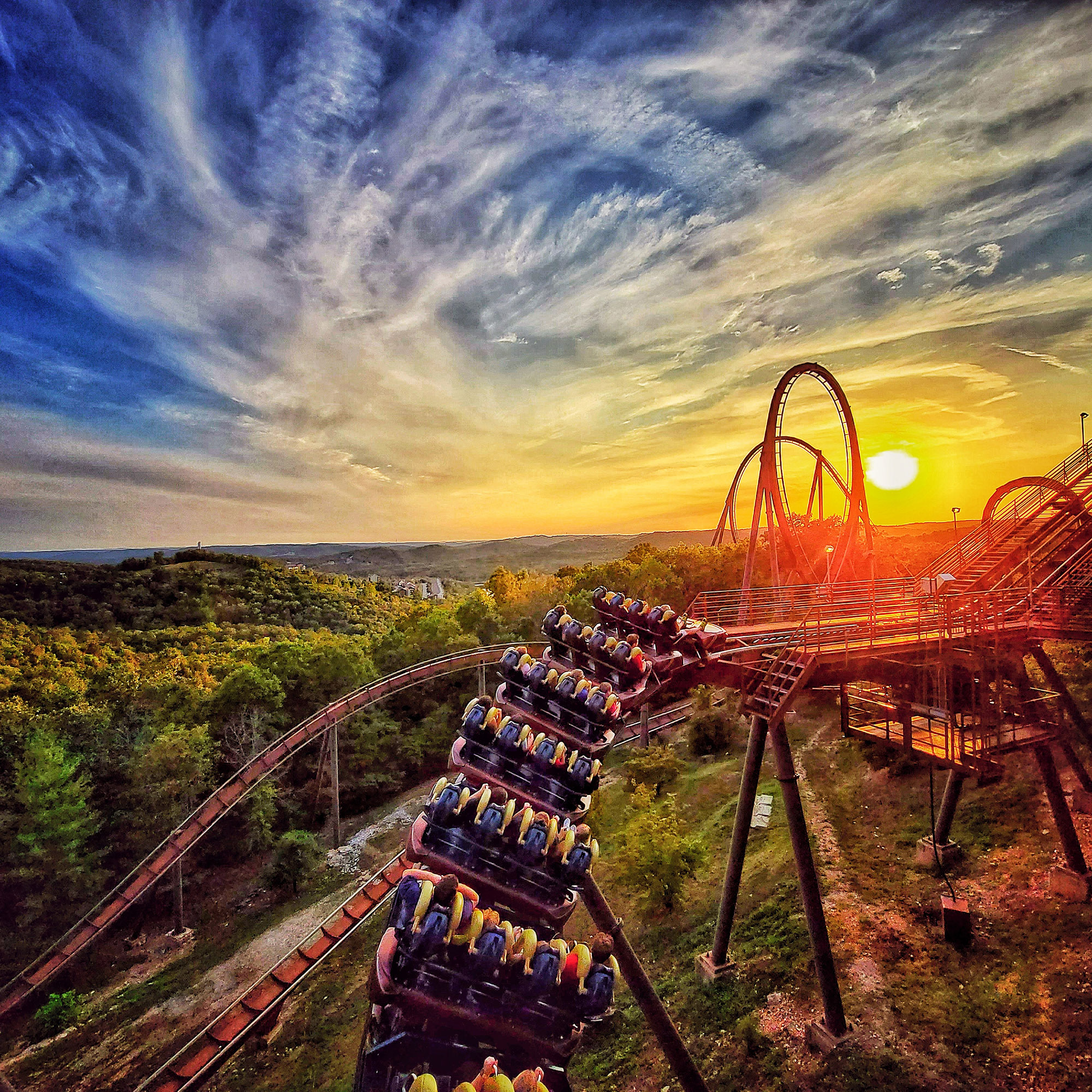Photo courtesy: Silver Dollar City. The image shows the Wildfire roller coaster with the sunset in the background.
