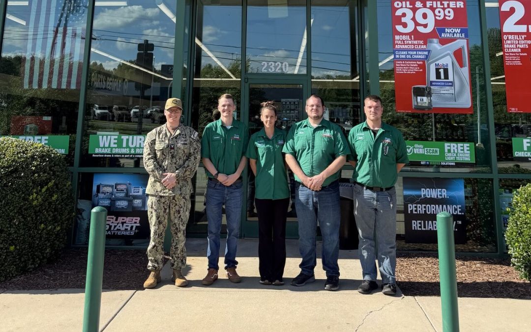 Cordell Criswell with Navy Reserves recruiter and O'Reilly Auto Parts team members in front of O'Reilly store.